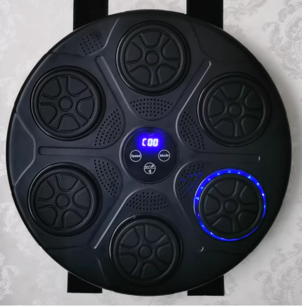 Black electronic device with circular ports and a digital display on a gray background